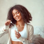 female model holding bottle with moisturising essence