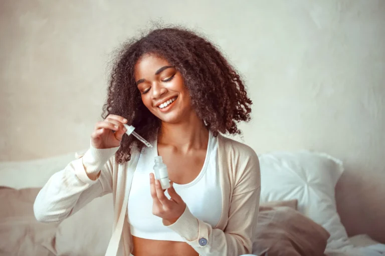female model holding bottle with moisturising essence