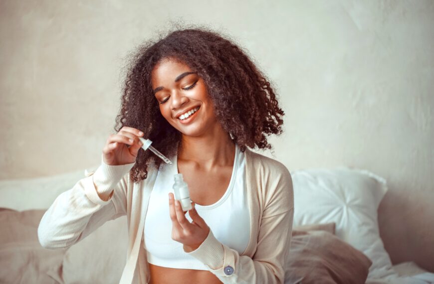 female model holding bottle with moisturising essence