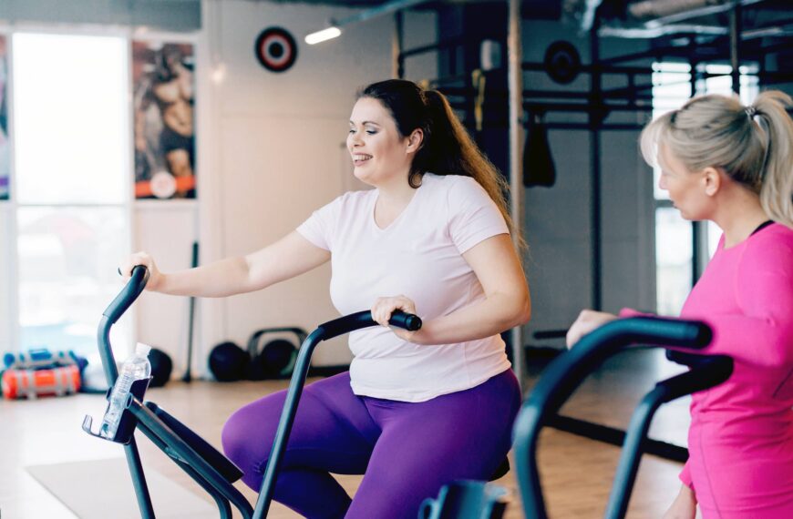 woman sits tired on stationary bike