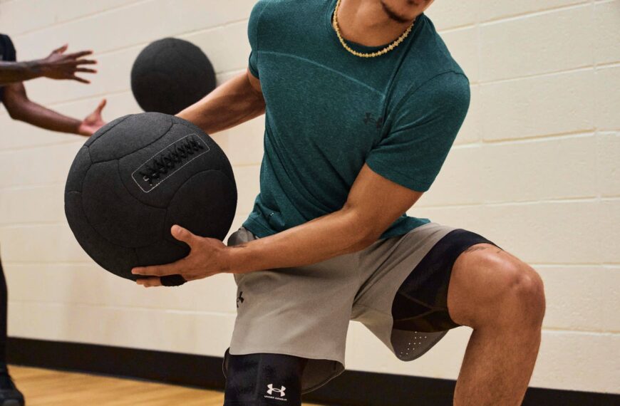 Fitness Person wearing Under Armour activewear throws medicine ball