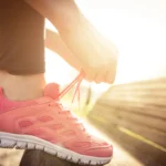 Person-laces-up-shoe