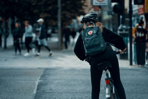 Female cyclist with backpack on bike