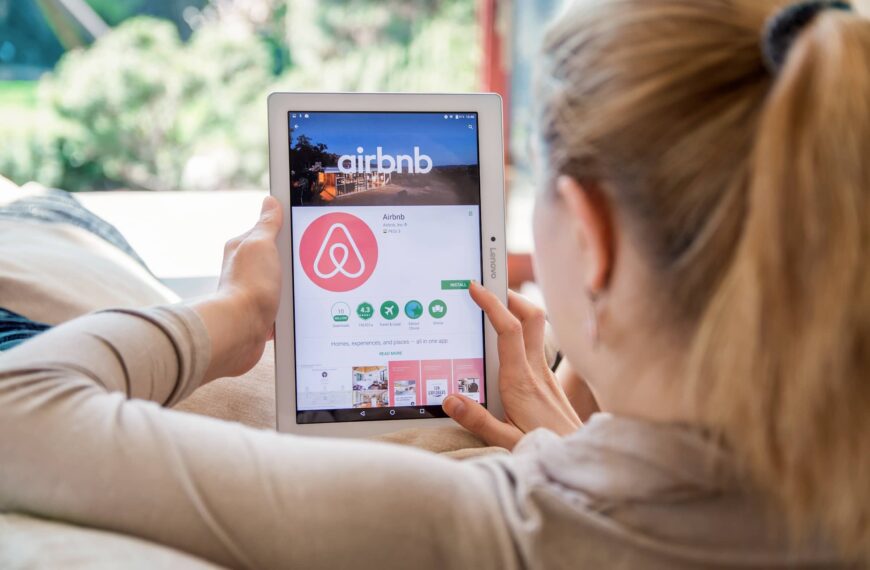 Woman is installing Airbnb application on Lenovo tablet.