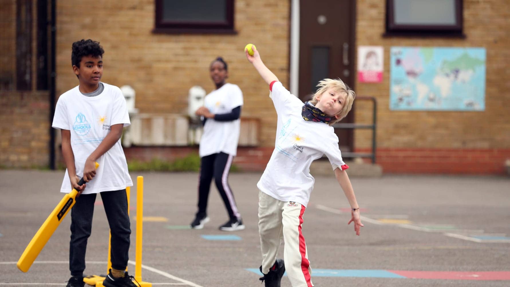 Youngsters play cricket in school playground