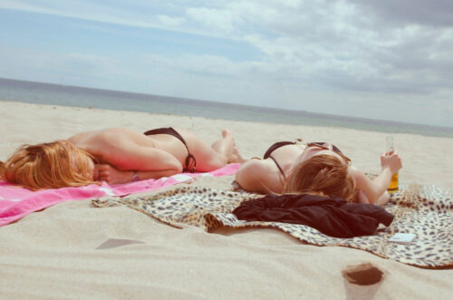 couple on beach sunbathe