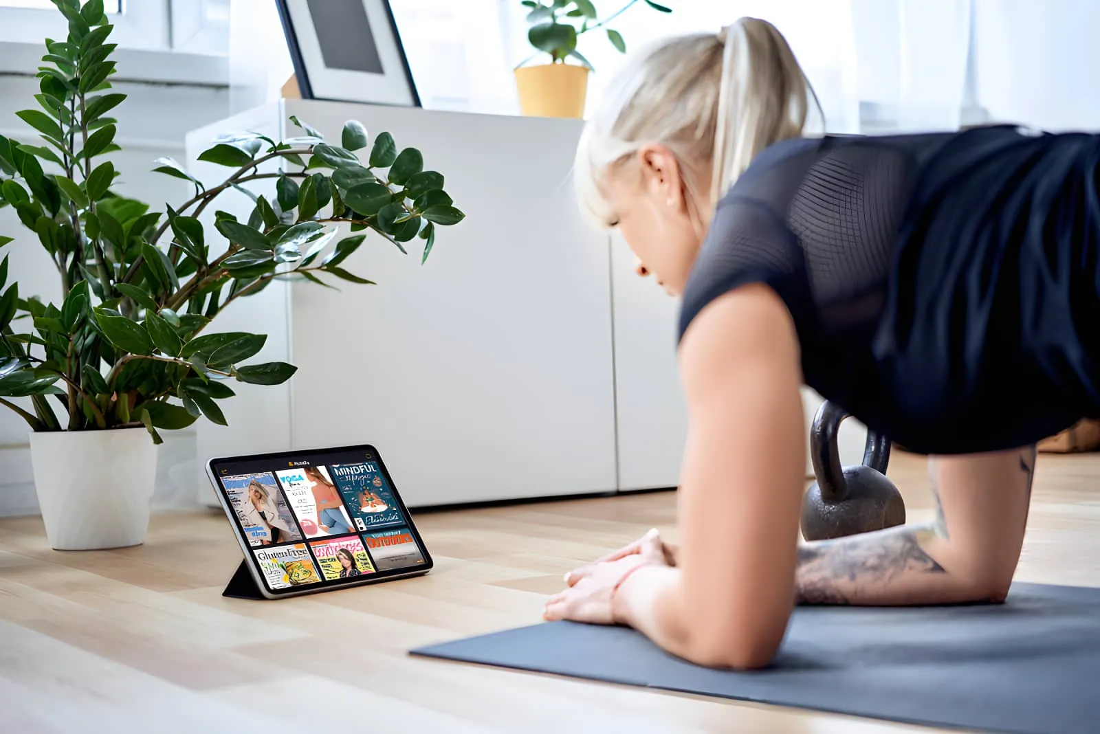 woman on tablet holding plank position