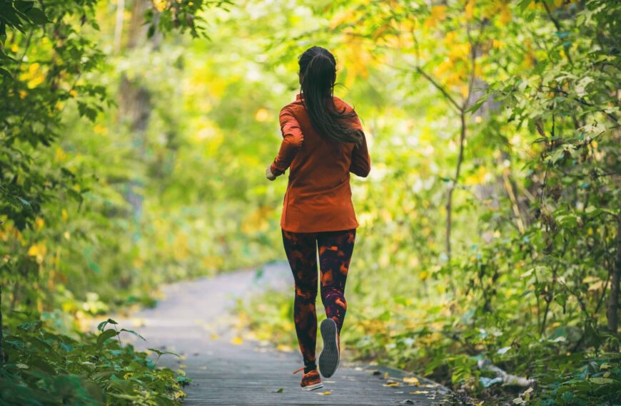 Run fit runner woman jogging in green spring forest woods park