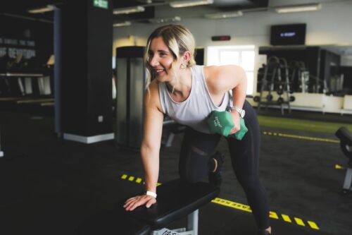 Woman lifts dumbell