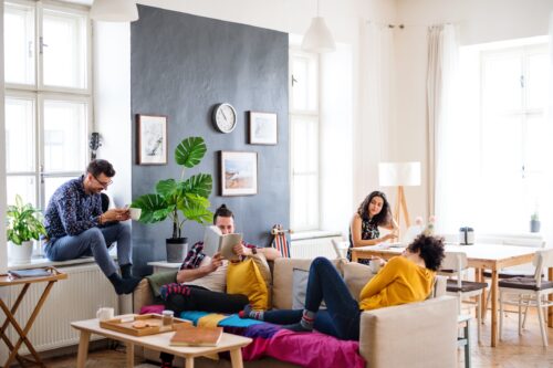 A group of young friends relaxing indoors, house sharing concept.