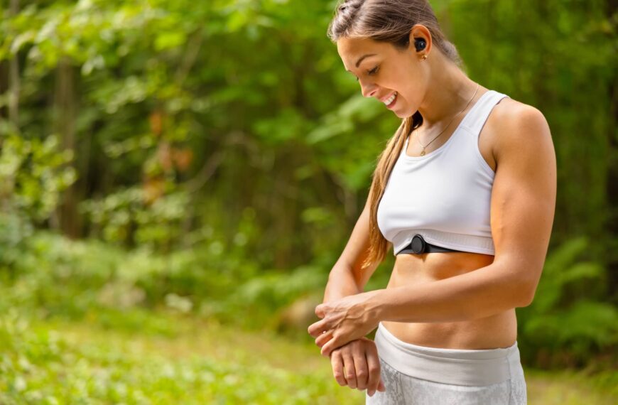 Well trained woman using fitness smart watch device under workout