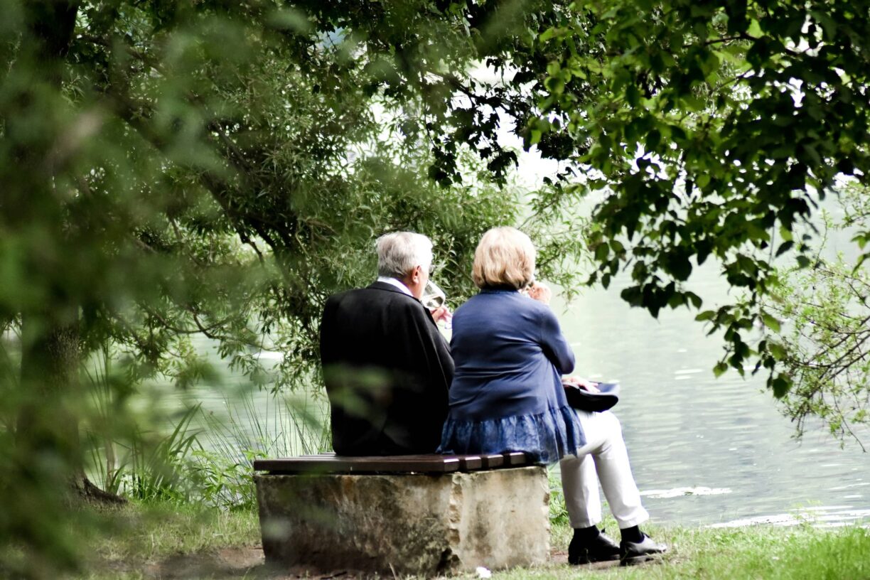 Couple sit over looking lake