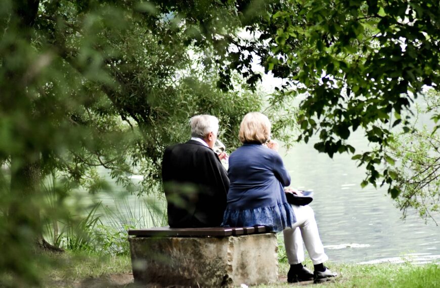 Couple sit over looking lake