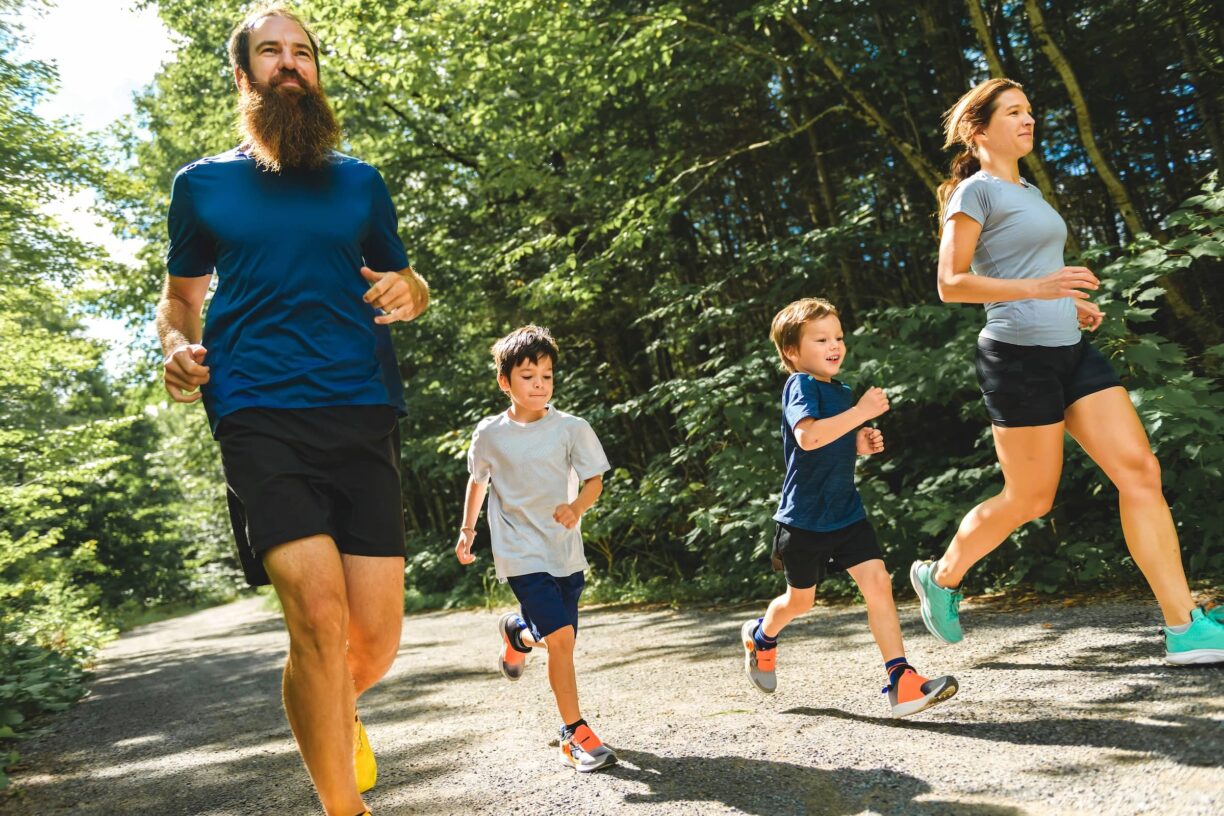 Family exercising and jogging together at an outdoor park