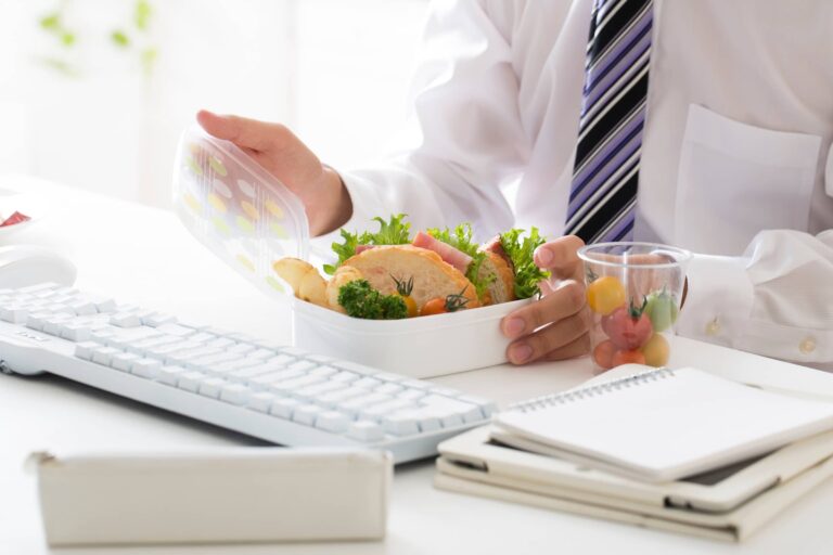 Office worker open lunch box at desk