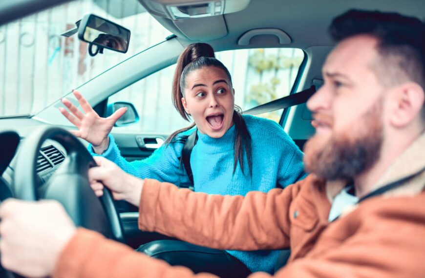 Person looks in horror at her partner driving