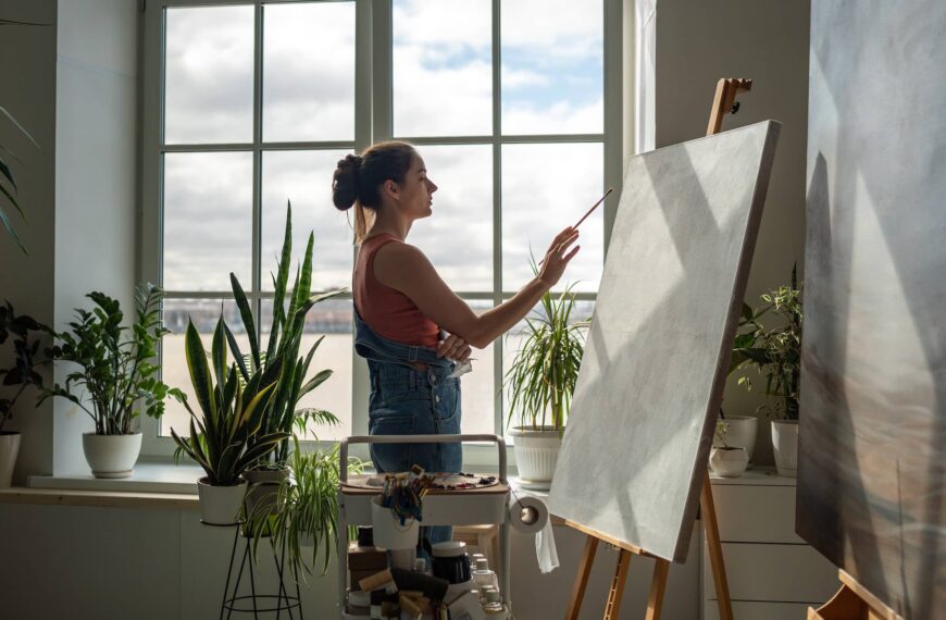 Thoughtful woman artist working on painting