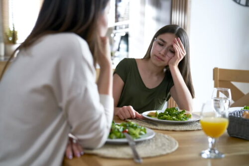 Woman looks upset over dinner