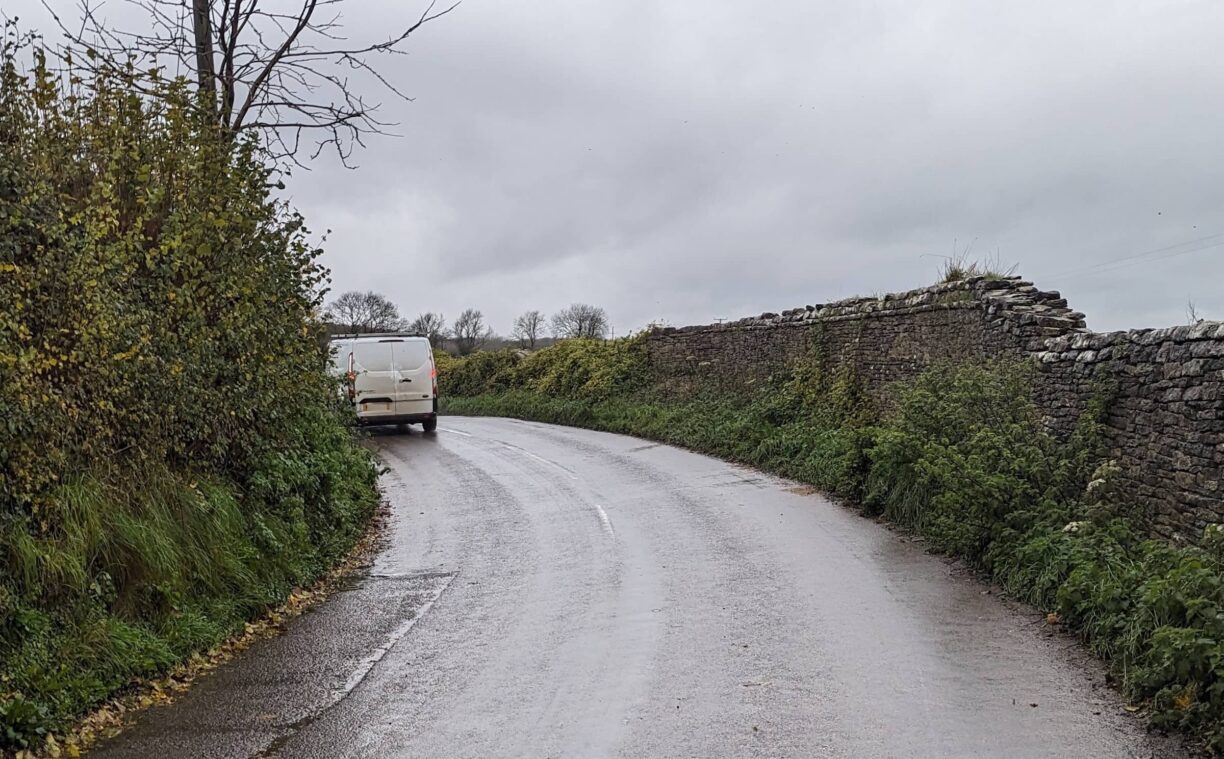 A blind corner on a country road, with a van and no path for walkers