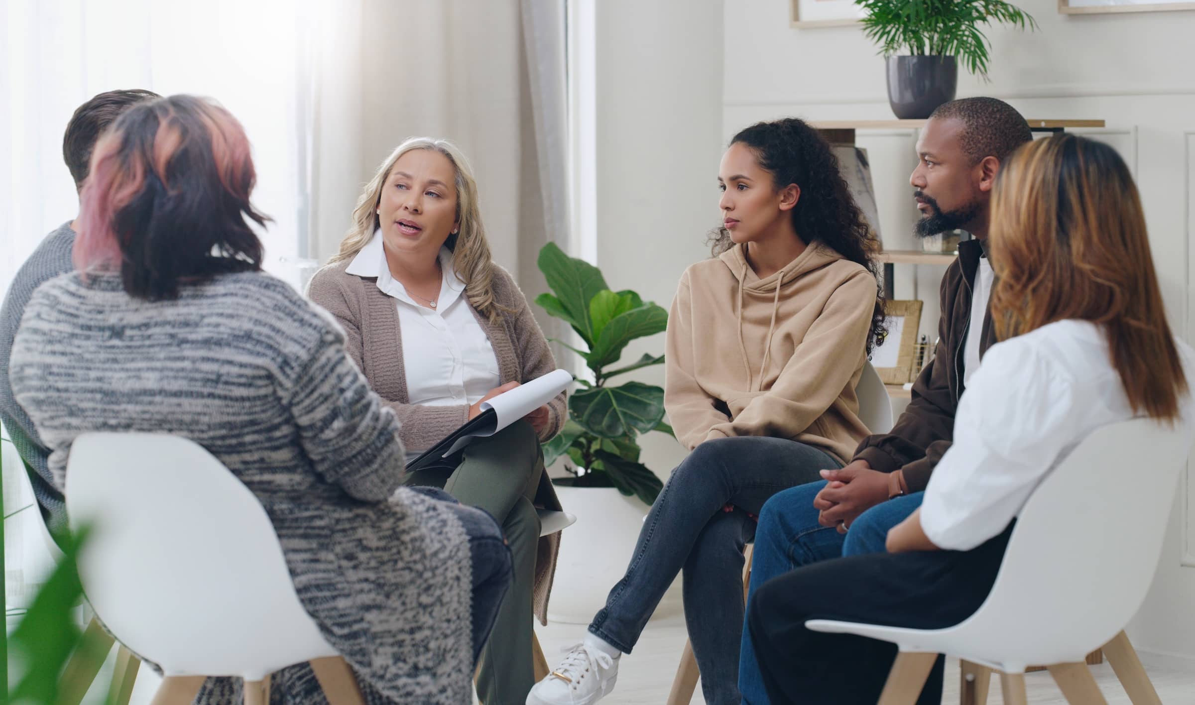 Men and women healing during psychologist meeting talking about mental health