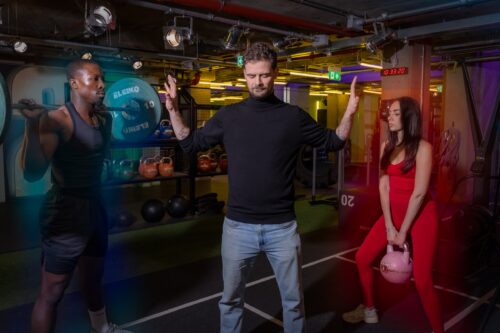 Gymbox Aura reader meditating between man and woman