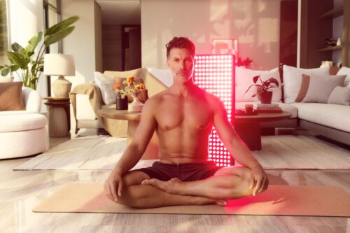 Man sits with Red Light behind him