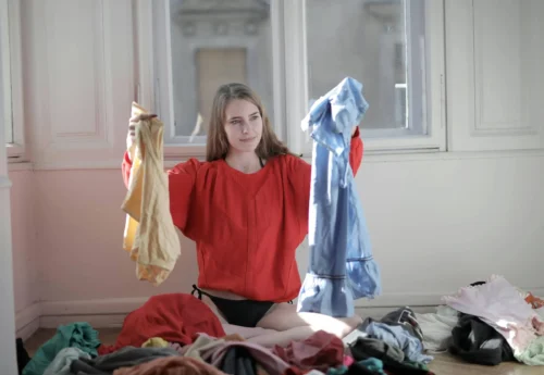 Person holds up clothing textiles