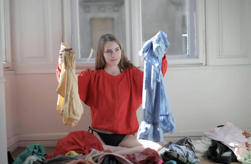 Person holds up clothing textiles