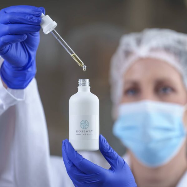 Scientist in lab mixing bottle