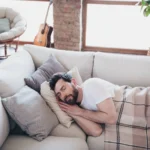 man lying on soft divan sleeping
