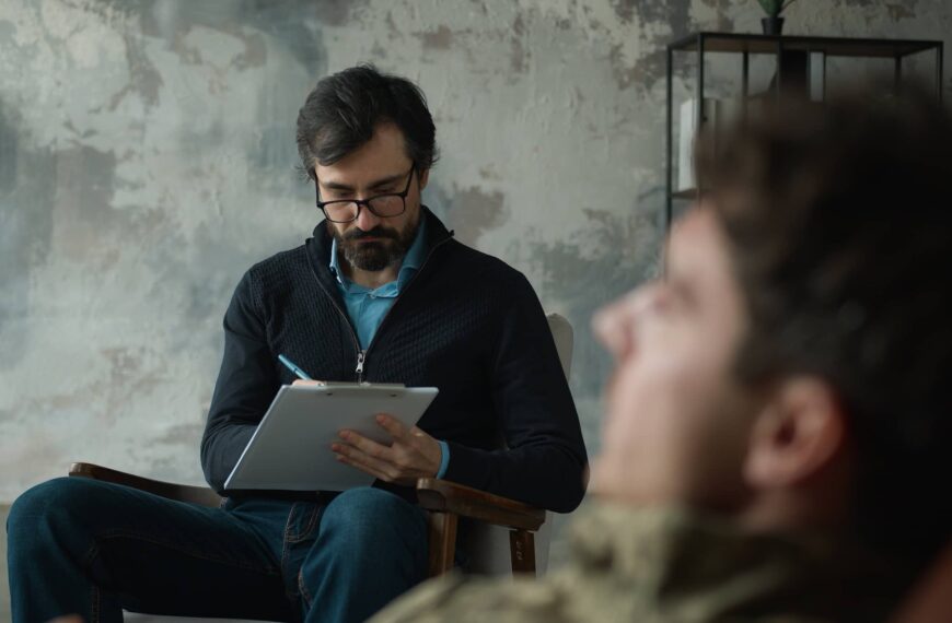 psychologist counselor writing notes listening patient client