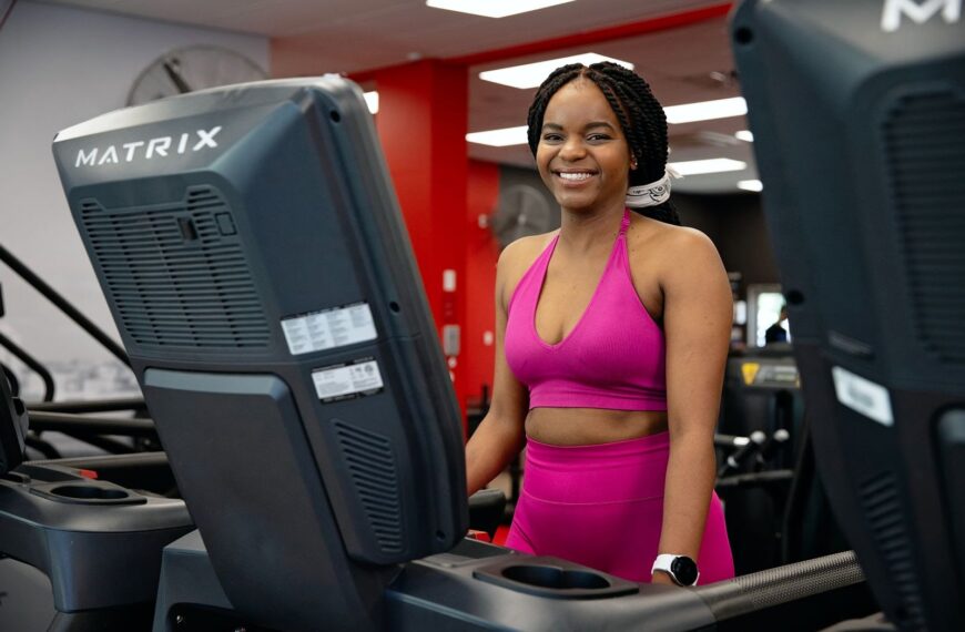 Gym goer on treadmill smiling