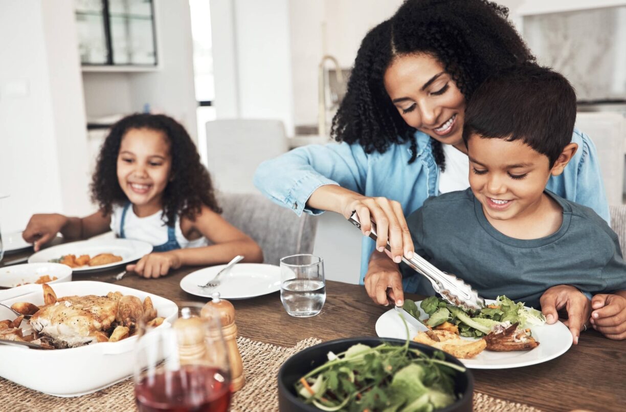 Mom, children and eating food in home together for lunch, dinner table and healthy meal