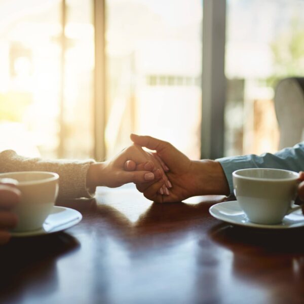 Tea time, couple and gesture in living room for compassion, hope and healing for emotional wellness with care