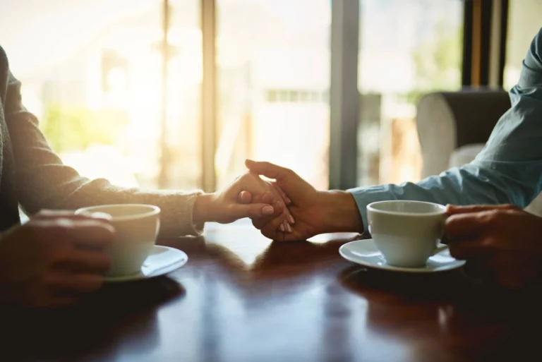 Tea time, couple and gesture in living room for compassion, hope and healing for emotional wellness with care