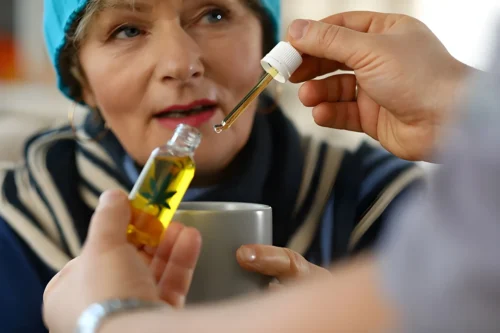 Woman looks at doctor with prescriptive cannabis oil