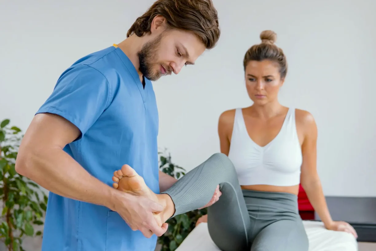 male-osteopathic-therapist-checking-female-patients-leg-movement