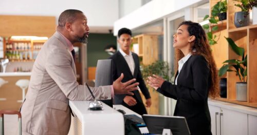 Businessman, woman angry argument for bad service at hotel