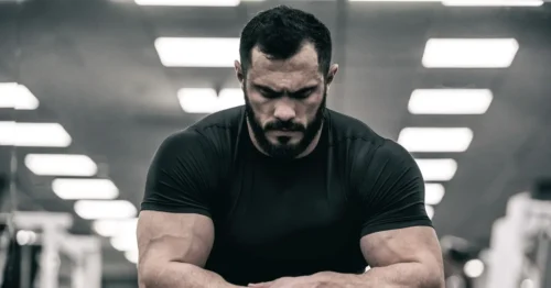 Man-looks-down-and-depressed-in-gym