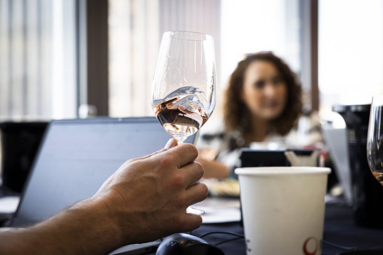Someone holding up a glass of wine
