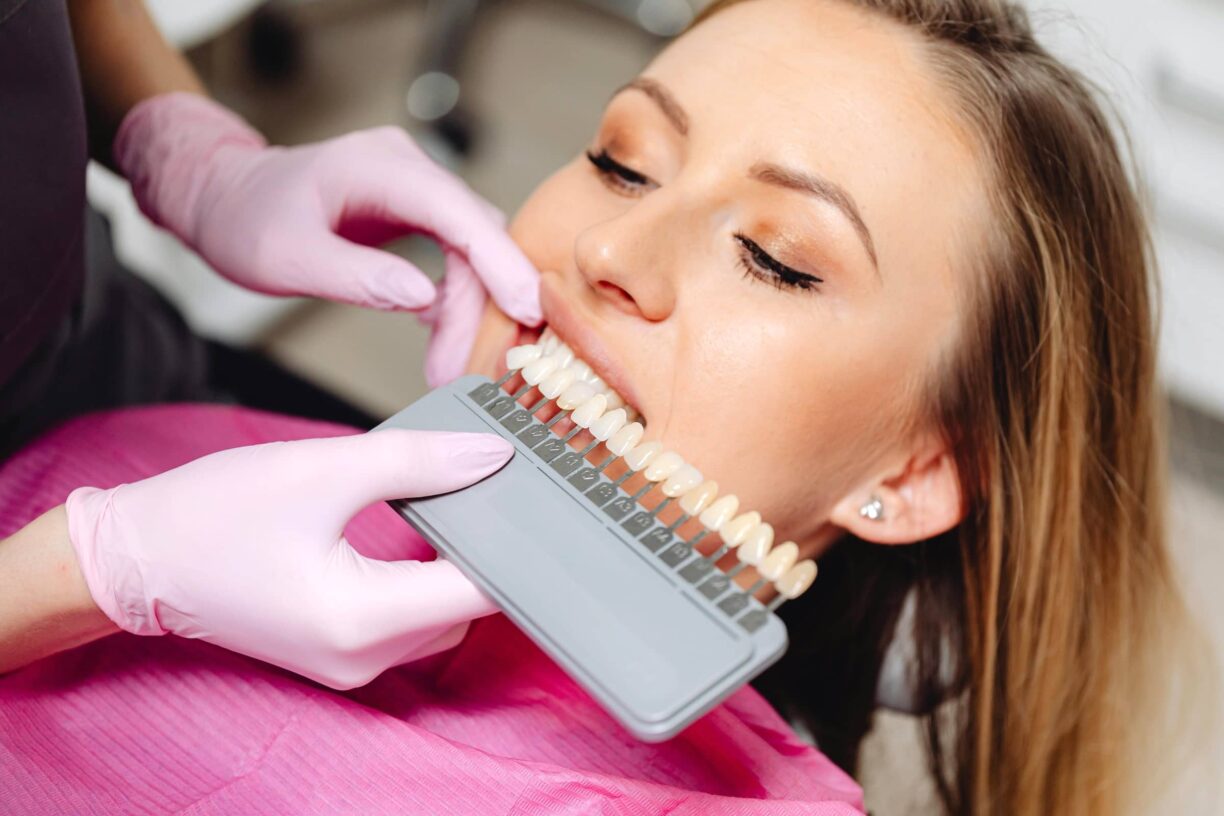 Dentist holds impants to patients mouth