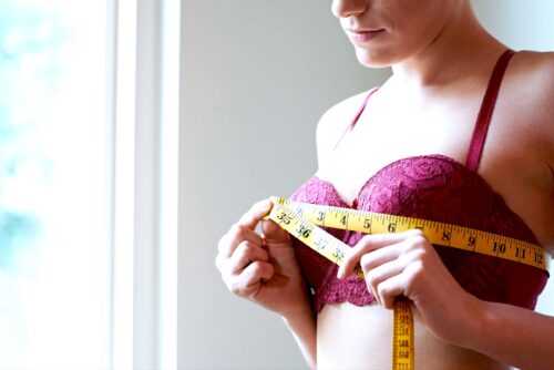 Woman measures across her bra