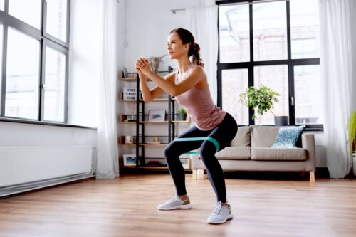 woman exercising with resistance band