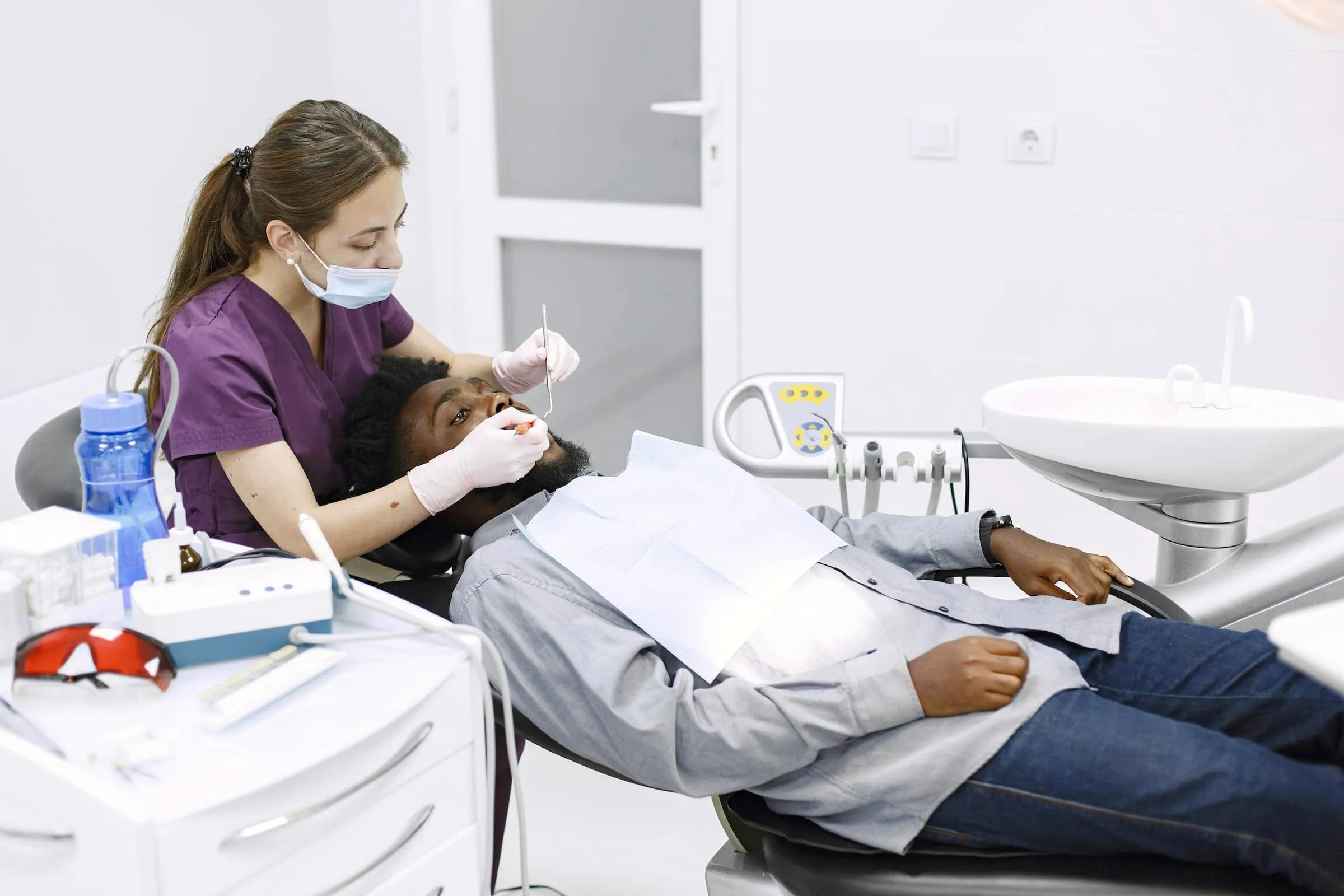 Dentist looks into mouth of patient