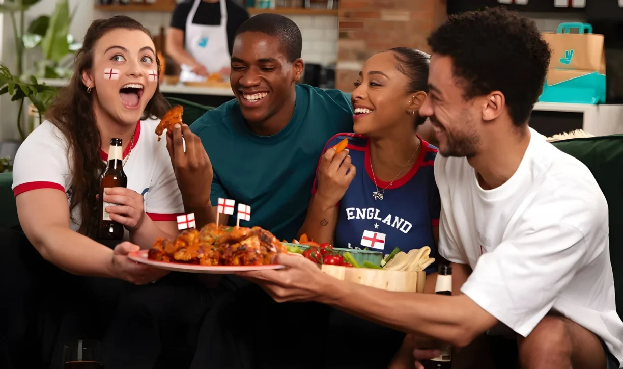 Football Fans Enjoying a Deliveroo Delivery of Food