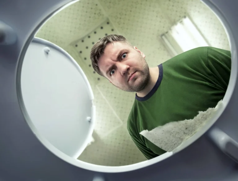 Man looking in the toilet bowl