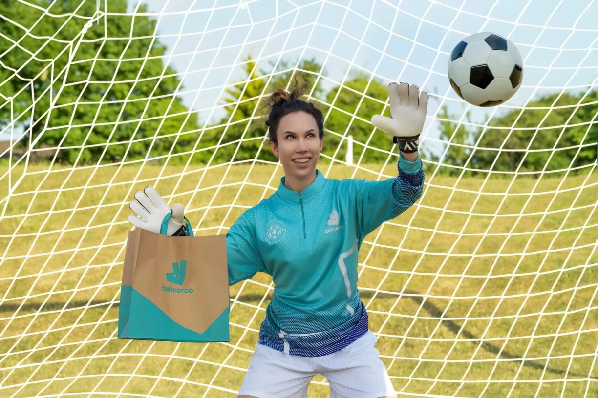 Woman in Goal wearing Deliveroo Delivery Items