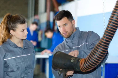 mechanic showing how the extractor to remove fumes