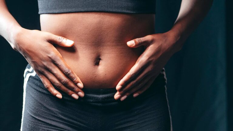 Hands feeling across stomach