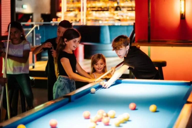 Kids play pool at Bat and Ball
